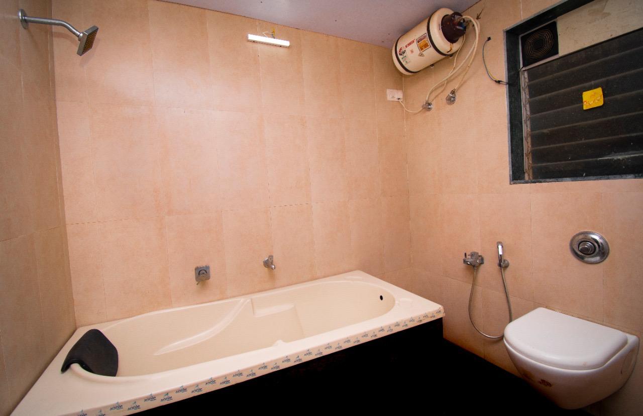 Clean and modern bathroom featuring a spacious bathtub and sleek finishes