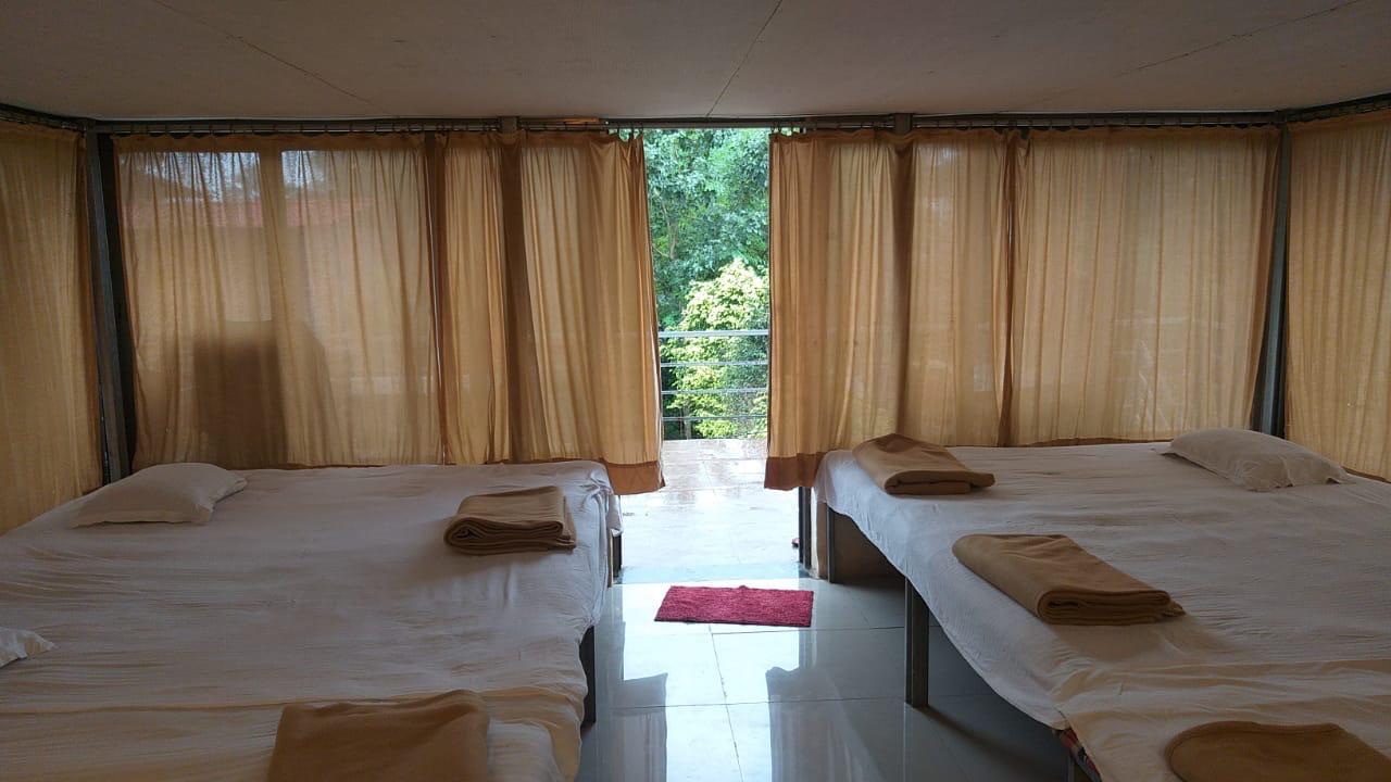 Charming bedroom interior with large glass windows overlooking nature