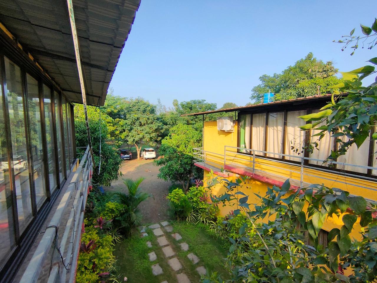 Scenic high-angle overview of the yellow cottage architecture and green surroundings